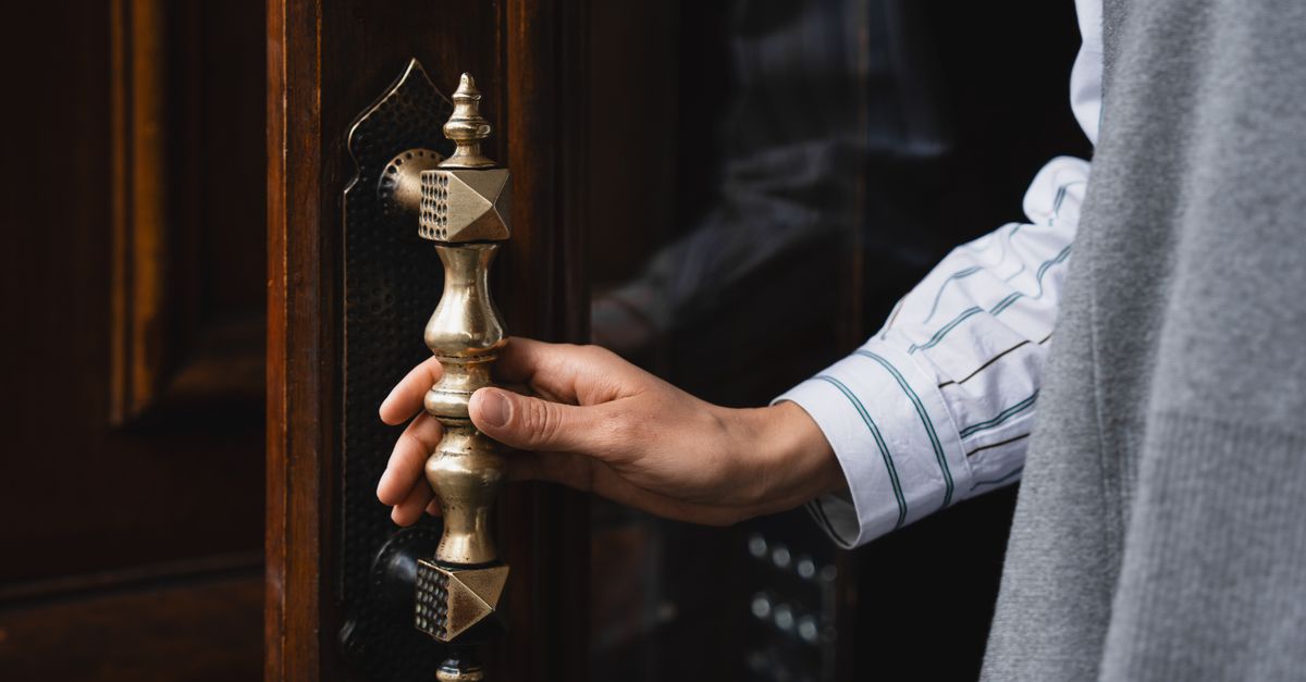 locksmith unlocking front door — Millburn Locksmith Inc